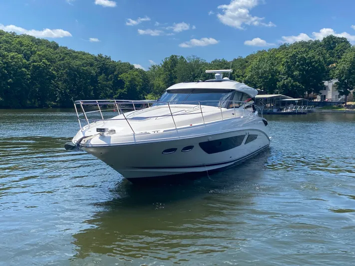  Yacht Photos Pics 2015 Sea Ray 470 Sundancer yacht cruising on a serene lake under a clear blue sky.