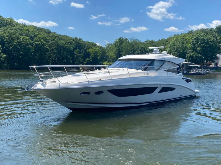  Yacht Photos Pics 2015 Sea Ray 470 Sundancer yacht on a serene lake with lush green trees.