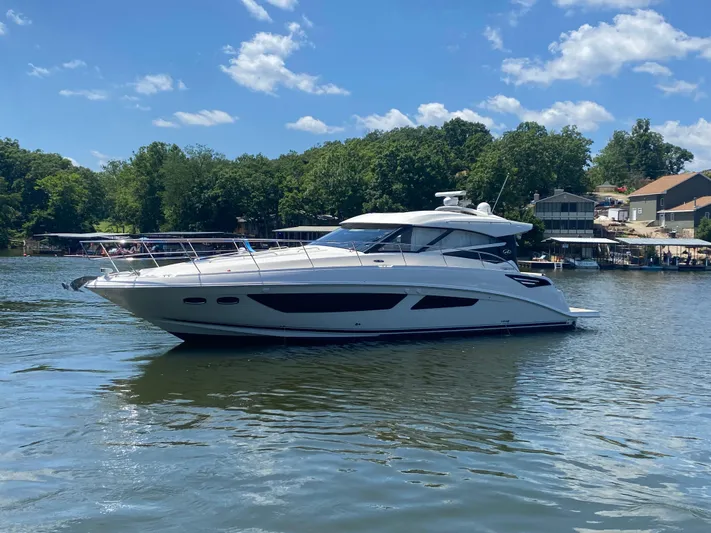  Yacht Photos Pics 2015 Sea Ray 470 Sundancer yacht on a serene lake with lush greenery.