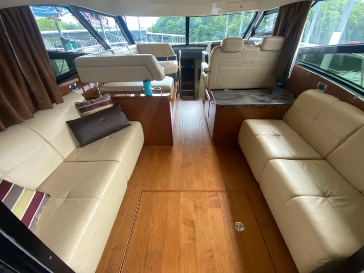  Yacht Photos Pics Luxurious interior of 2015 Sea Ray 470 Sundancer yacht with leather seating and wood flooring.