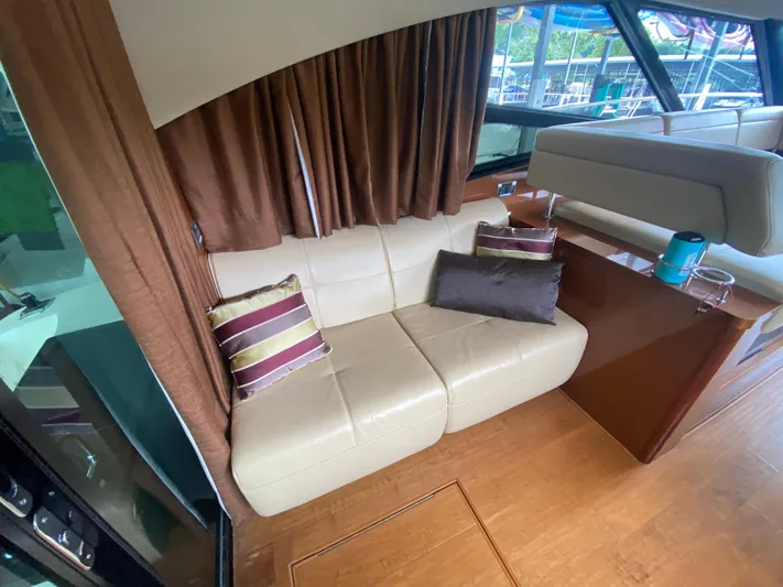  Yacht Photos Pics Luxurious interior of 2015 Sea Ray 470 Sundancer with cream leather sofa and striped cushions.