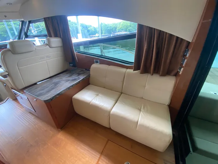  Yacht Photos Pics Interior of 2015 Sea Ray 470 Sundancer yacht with beige seating and wooden accents.