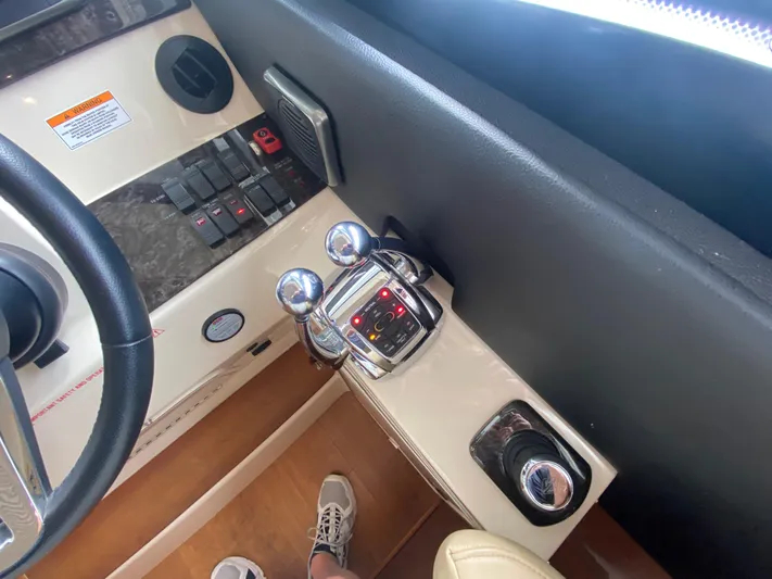  Yacht Photos Pics Control panel of a 2015 Sea Ray 470 Sundancer yacht, featuring steering and throttle controls.