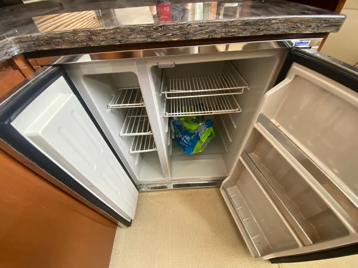  Yacht Photos Pics Open refrigerator inside 2015 Sea Ray 470 Sundancer yacht, showing shelves and bottled water.