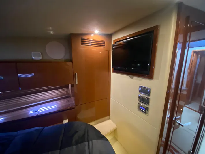  Yacht Photos Pics Luxurious interior of 2015 Sea Ray 470 Sundancer yacht with TV and wooden cabinetry.