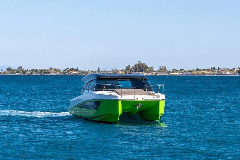  Yacht Photos Pics 2025 Makai M37 catamaran cruising on blue ocean near coastline.