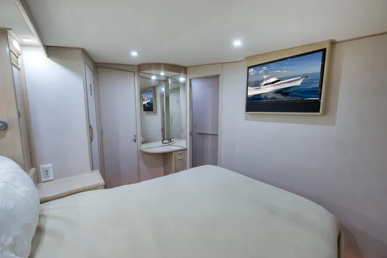Rose Yacht Photos Pics Luxurious 1998 Rybovich Convertible yacht bedroom with modern decor and wall-mounted TV.