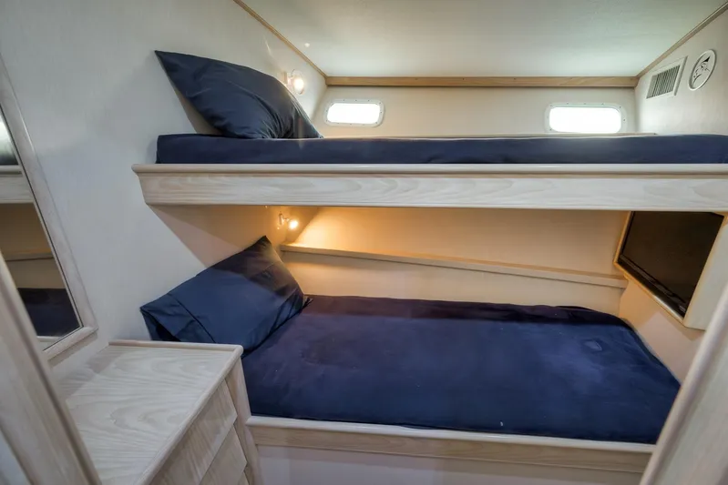 Rose Yacht Photos Pics 1998 Rybovich Convertible yacht interior with cozy bunk beds and soft lighting.