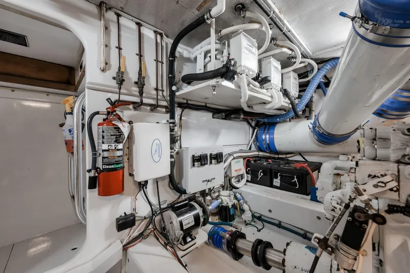 Rose Yacht Photos Pics Engine room of a 1998 Rybovich Convertible boat, featuring mechanical and electrical components.