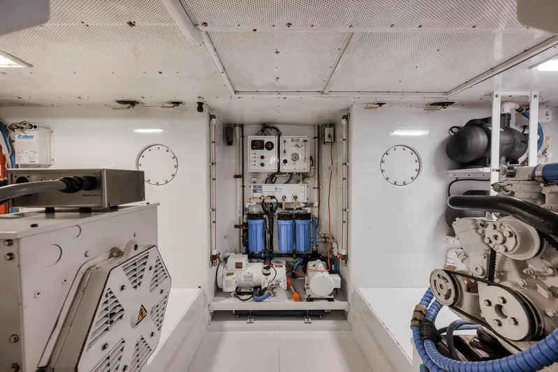 Rose Yacht Photos Pics Engine room of a 1998 Rybovich Convertible yacht, featuring mechanical equipment and systems.