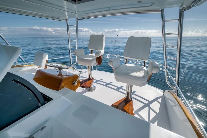 Rose Yacht Photos Pics 1998 Rybovich Convertible yacht helm with ocean view, featuring two white captain chairs.