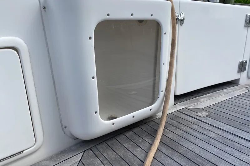 Island Time Yacht Photos Pics Riviera 4000 yacht deck detail, featuring a white panel and wooden flooring, 2000 model.