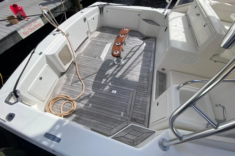 Island Time Yacht Photos Pics Spacious deck of 2000 Riviera 4000 boat with wooden flooring and seating.