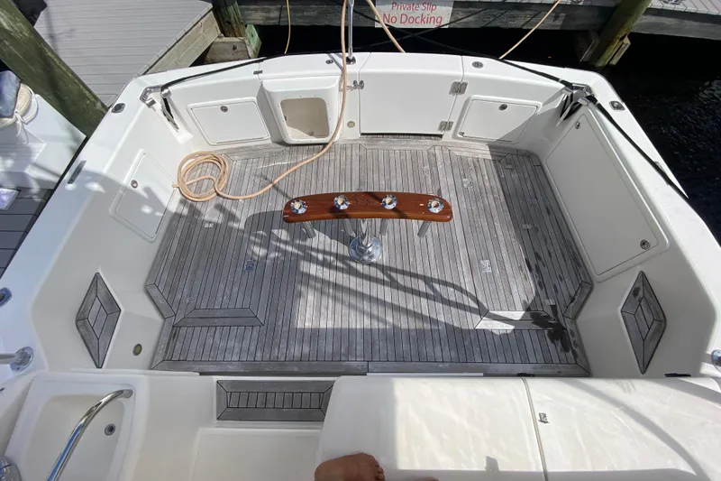 Island Time Yacht Photos Pics Spacious deck of 2000 Riviera 4000 yacht with wooden flooring and fishing rod holders.