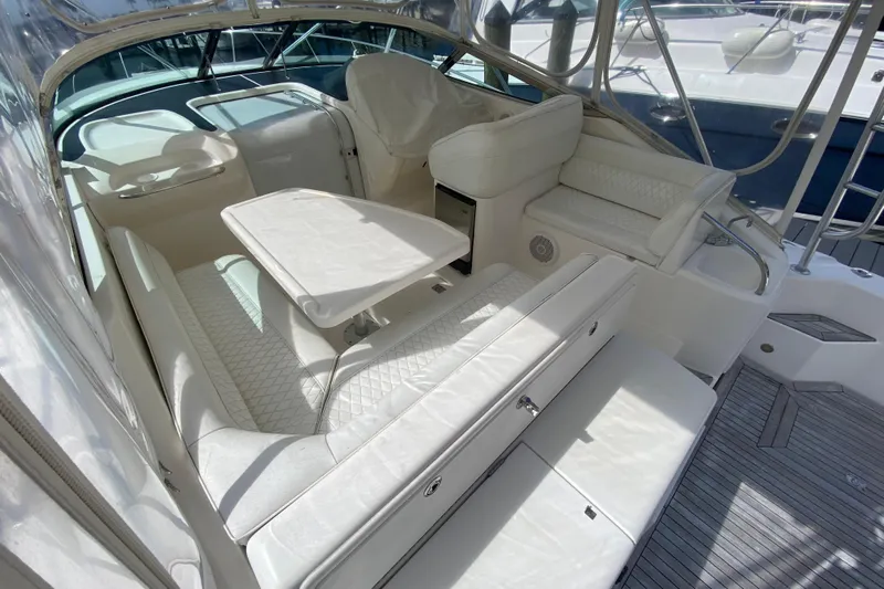 Island Time Yacht Photos Pics Luxurious interior of 2000 Riviera 4000 yacht with white seating and table.