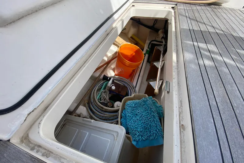 Island Time Yacht Photos Pics Storage compartment on 2000 Riviera 4000 boat with cleaning supplies and equipment.