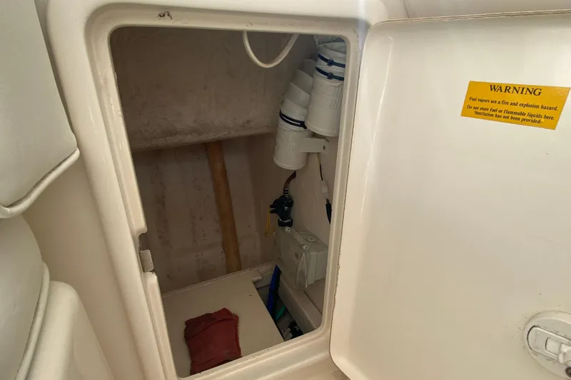 Island Time Yacht Photos Pics Riviera 4000 2000 model storage compartment with warning label and equipment inside.