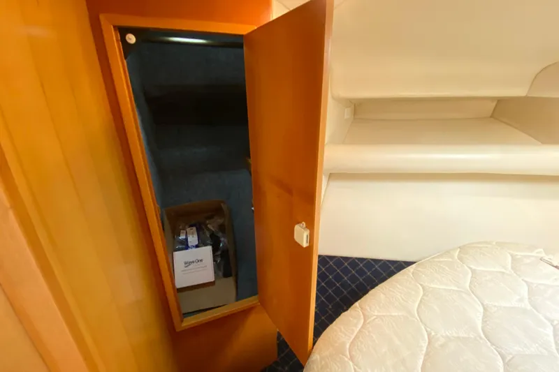 Island Time Yacht Photos Pics Interior of 2000 Riviera 4000 yacht showing open closet and bed area.