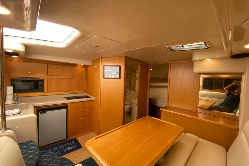 Island Time Yacht Photos Pics Interior of 2000 Riviera 4000 yacht with kitchen, dining area, and cozy seating.