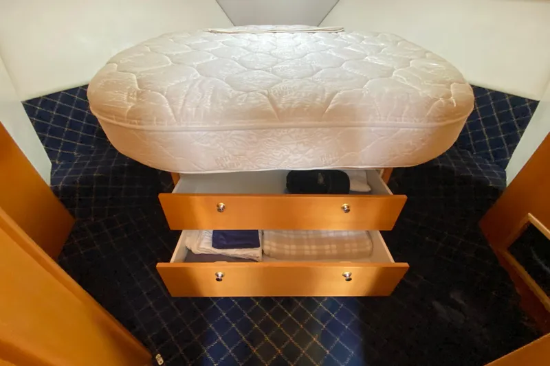Island Time Yacht Photos Pics Under-bed storage drawers in a 2000 Riviera 4000 yacht cabin.