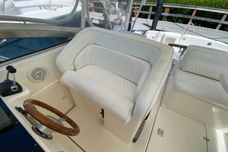 Island Time Yacht Photos Pics Luxurious 2000 Riviera 4000 yacht interior with white leather seating and wooden steering wheel.