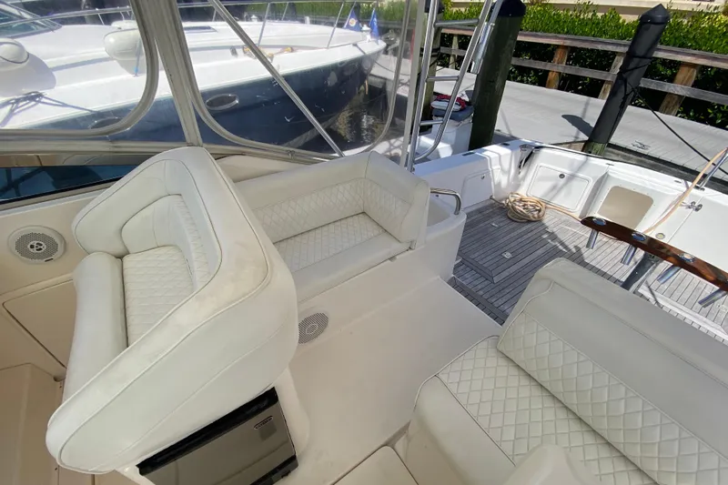 Island Time Yacht Photos Pics Luxurious 2000 Riviera 4000 yacht interior with white leather seating and teak flooring.