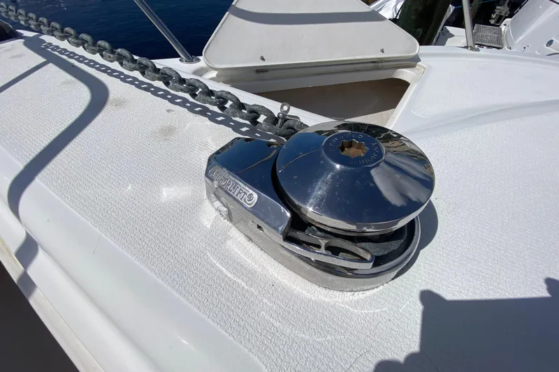 Island Time Yacht Photos Pics Anchor windlass on 2000 Riviera 4000 yacht deck, with chain and polished metal finish.