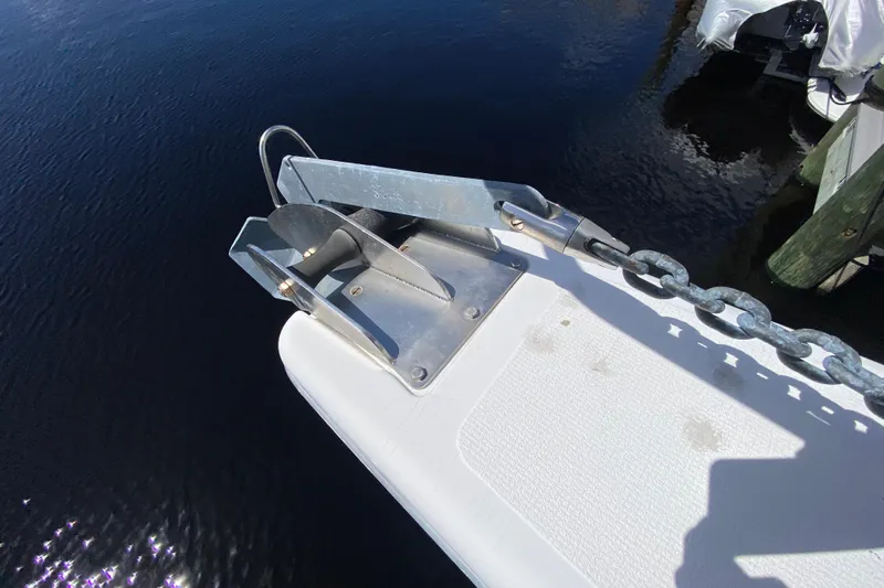 Island Time Yacht Photos Pics Anchor and chain on a 2000 Riviera 4000 boat, docked by the water.