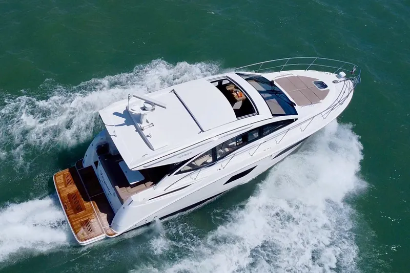  Yacht Photos Pics 2017 Sea Ray Sundancer 400 yacht cruising on open water, aerial view.