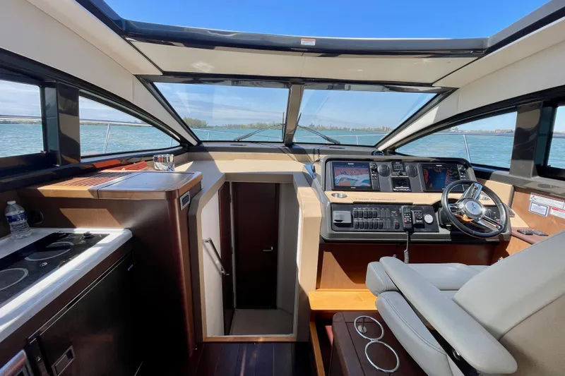  Yacht Photos Pics Interior view of 2017 Sea Ray Sundancer 400 yacht cockpit with modern controls and panoramic windows.
