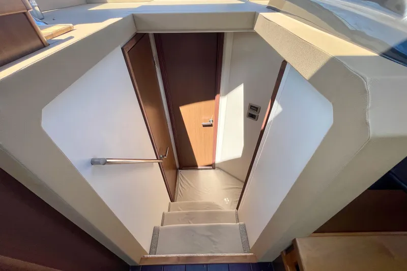  Yacht Photos Pics Stairway inside 2017 Sea Ray Sundancer 400 yacht, featuring sleek design and wooden door.