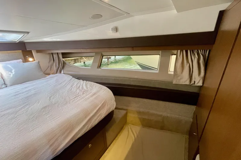  Yacht Photos Pics Luxurious cabin interior of 2017 Sea Ray Sundancer 400 yacht with large bed and windows.