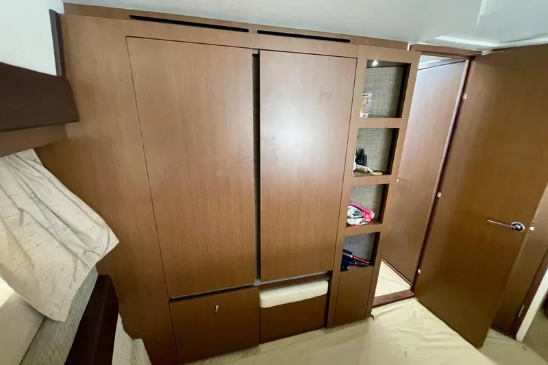  Yacht Photos Pics 2017 Sea Ray Sundancer 400 interior with wooden cabinetry and open shelving.