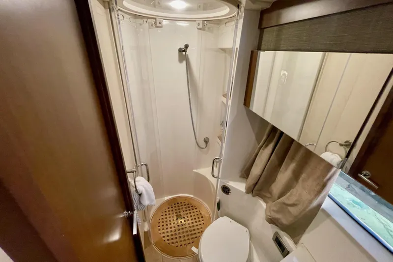  Yacht Photos Pics Bathroom interior of 2017 Sea Ray Sundancer 400 yacht, featuring shower and toilet.