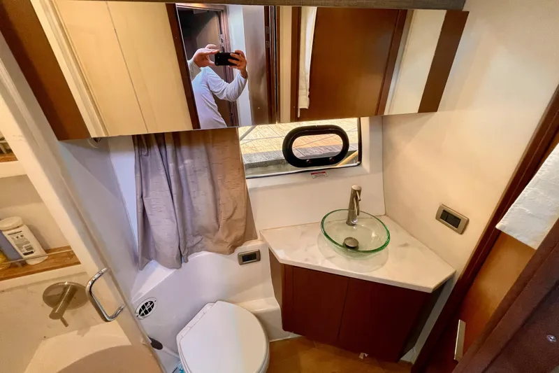  Yacht Photos Pics Bathroom interior of 2017 Sea Ray Sundancer 400 yacht with modern fixtures and mirror.
