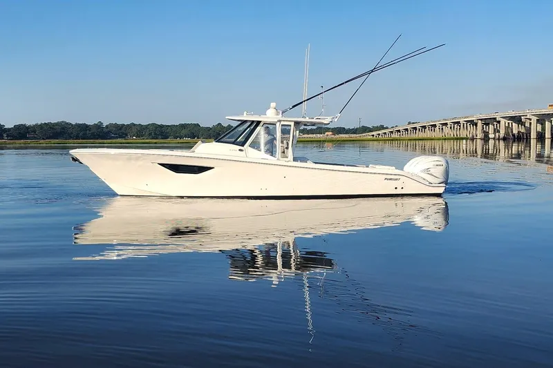  Yacht Photos Pics 2023 Pursuit S 378 Sport boat on calm water near a bridge.
