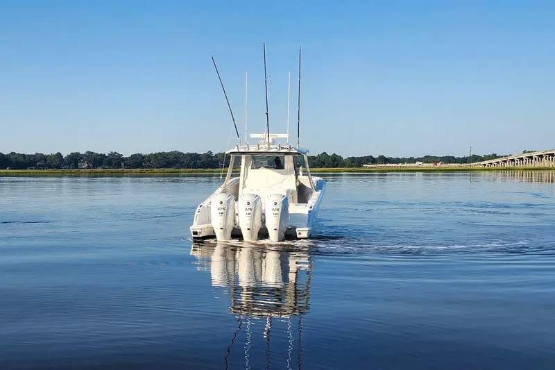  Yacht Photos Pics 2023 Pursuit S 378 Sport boat on calm water with clear blue sky.