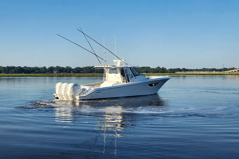  Yacht Photos Pics 2023 Pursuit S 378 Sport boat cruising on calm water under clear blue sky.
