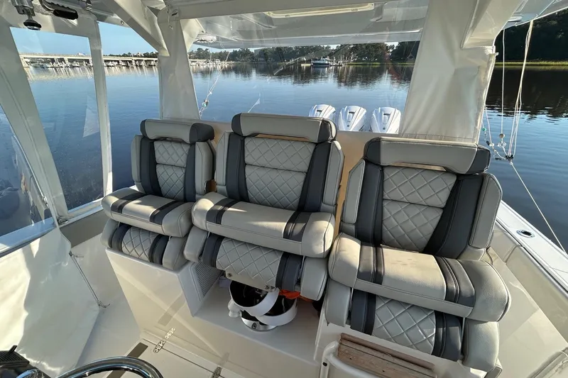  Yacht Photos Pics 2023 Pursuit S 378 Sport boat interior with luxurious seating and scenic water view.