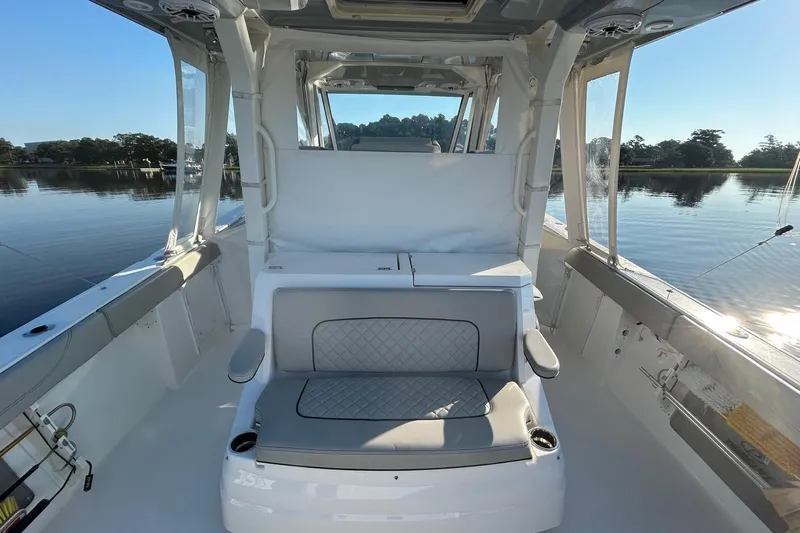  Yacht Photos Pics 2023 Pursuit S 378 Sport boat interior with cushioned seating and scenic water view.