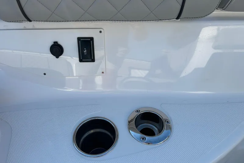  Yacht Photos Pics 2023 Pursuit S 378 Sport boat interior with cup holders and control switch.