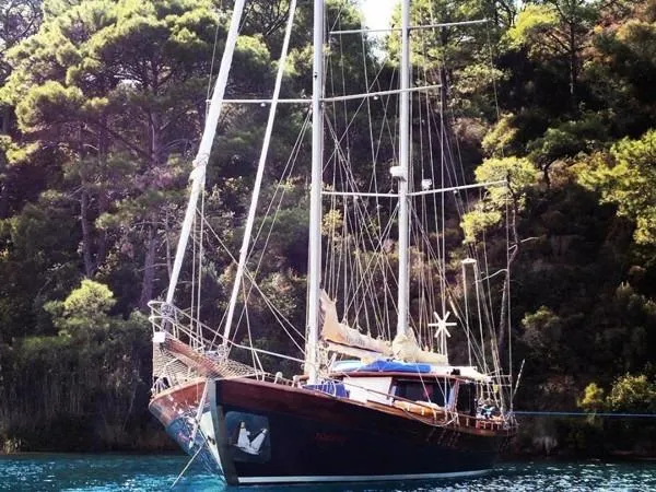 Trİppİn Yacht Photos Pics Wooden Ketch Tirhandil 20M, 2006, anchored in a scenic forested bay.