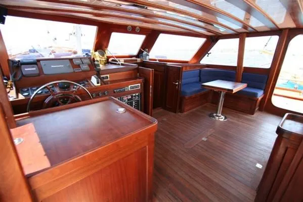 Trİppİn Yacht Photos Pics Interior of a 2006 Custom Wooden Ketch Tirhandil 20M with wooden finish and seating area.
