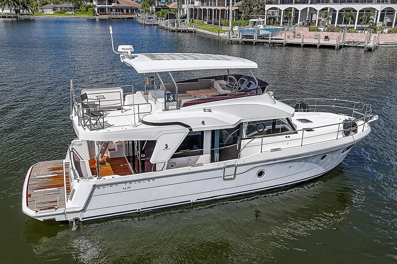 Horizon IV Yacht Photos Pics 2020 Beneteau Swift Trawler 47 cruising on a calm waterway.