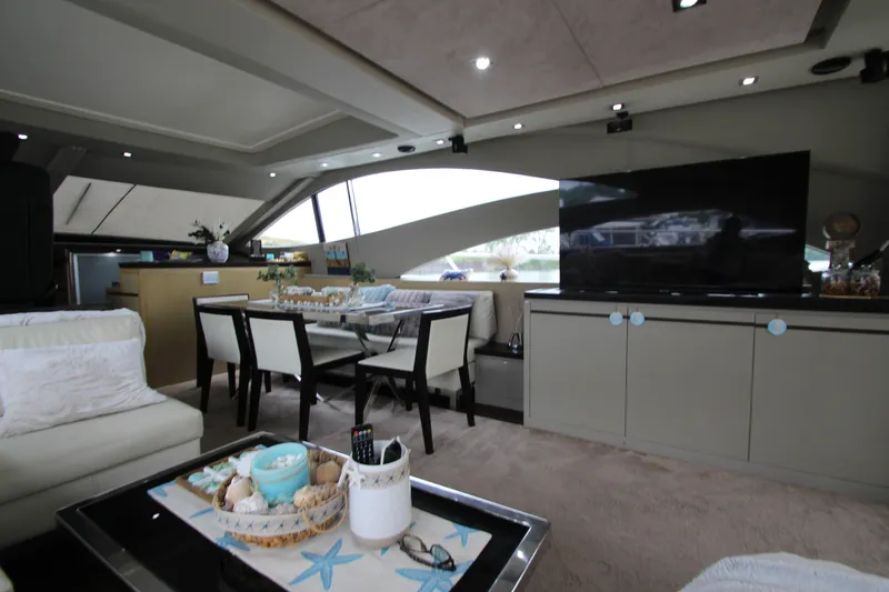  Yacht Photos Pics Luxurious interior of 2007 Uniesse 70 Sport yacht with modern dining and living area.