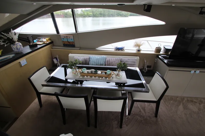  Yacht Photos Pics Luxurious interior of 2007 Uniesse 70 Sport yacht with elegant dining area.