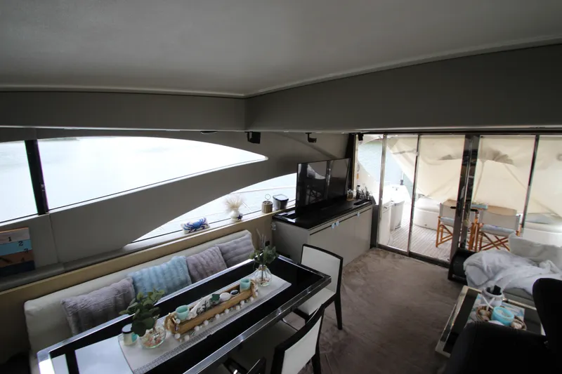  Yacht Photos Pics Luxurious interior of 2007 Uniesse 70 Sport yacht with modern furnishings and large windows.