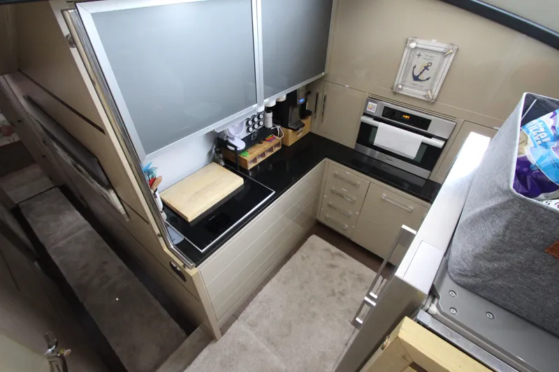  Yacht Photos Pics Modern kitchen in 2007 Uniesse 70 Sport yacht with sleek countertops and appliances.