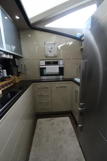  Yacht Photos Pics Modern kitchen interior on 2007 Uniesse 70 Sport yacht, featuring sleek cabinetry and stainless steel appliances.