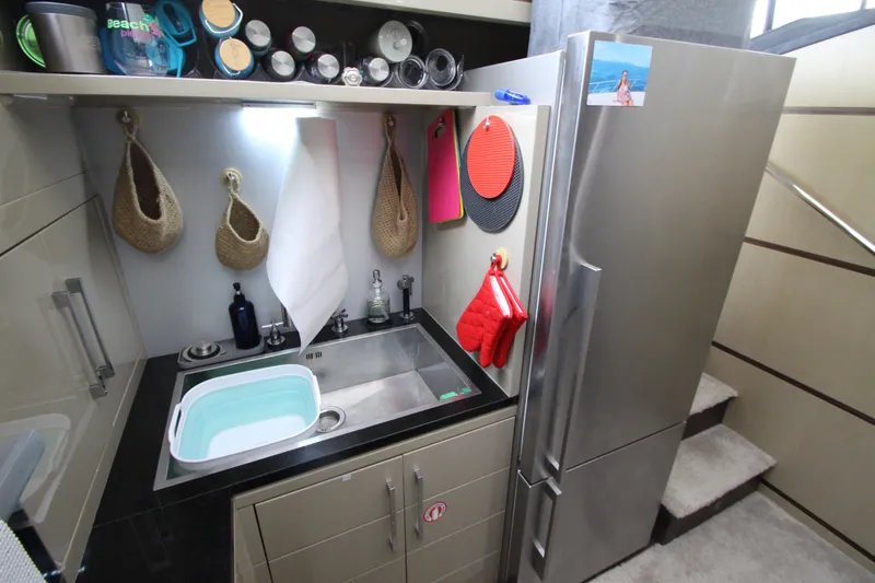  Yacht Photos Pics Compact kitchen area in a 2007 Uniesse 70 Sport yacht with modern appliances.